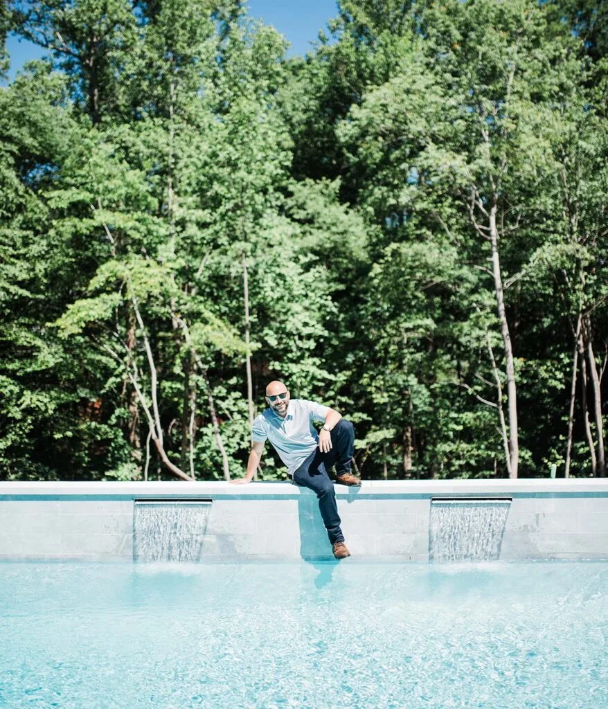 Chris Jones sitting on pool wall