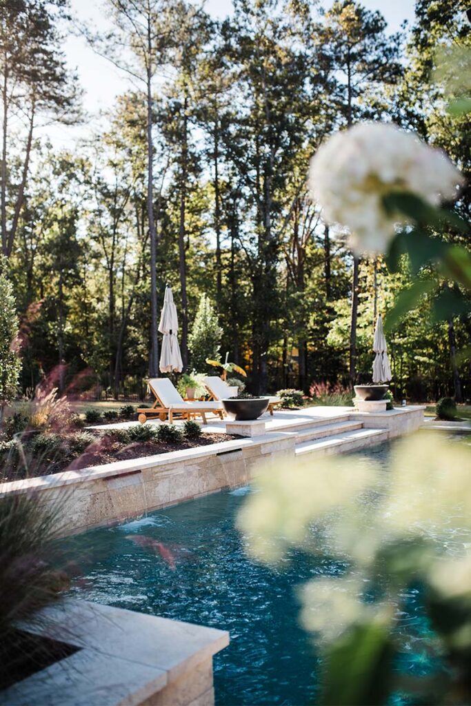 Wide shot of concrete pool with retaining wall surrounds.