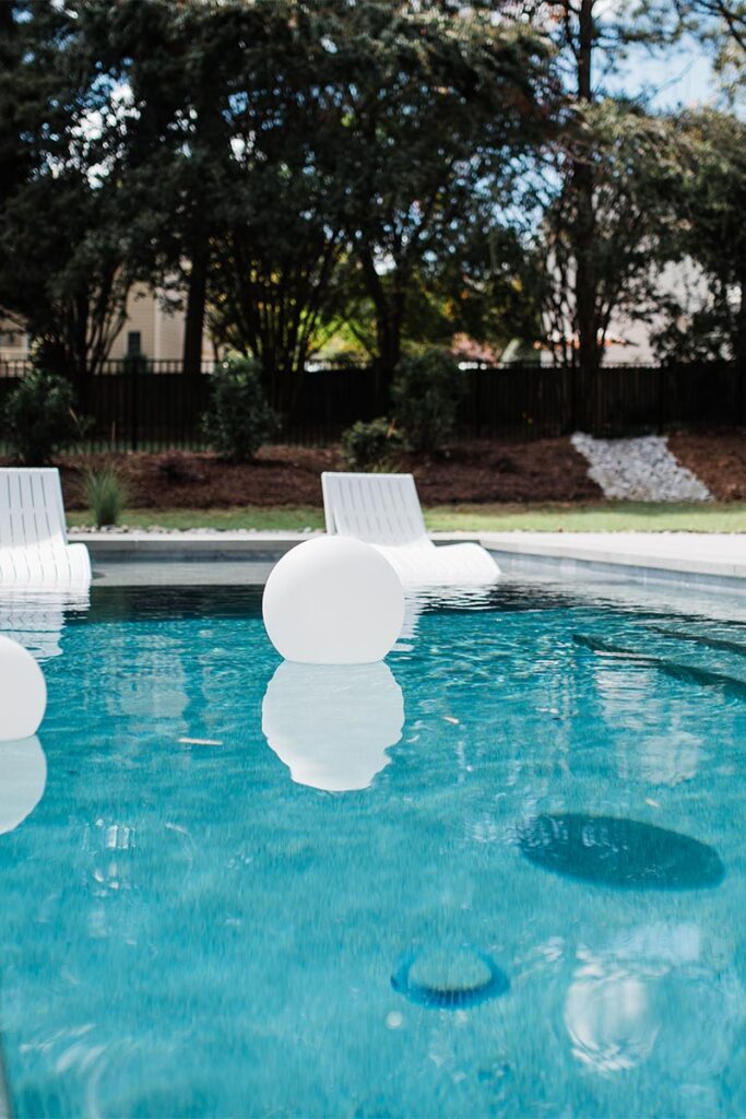 Pool design with floating chairs and spheres, in Raleigh.