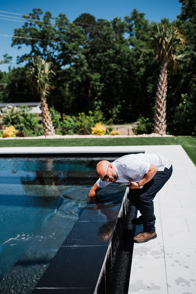 Chris Jones testing pool water