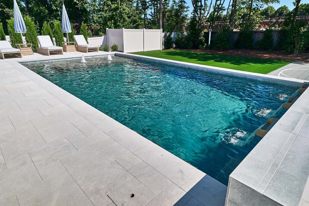 Contemporary Apex concrete pool with custom pool surrounds and water jets