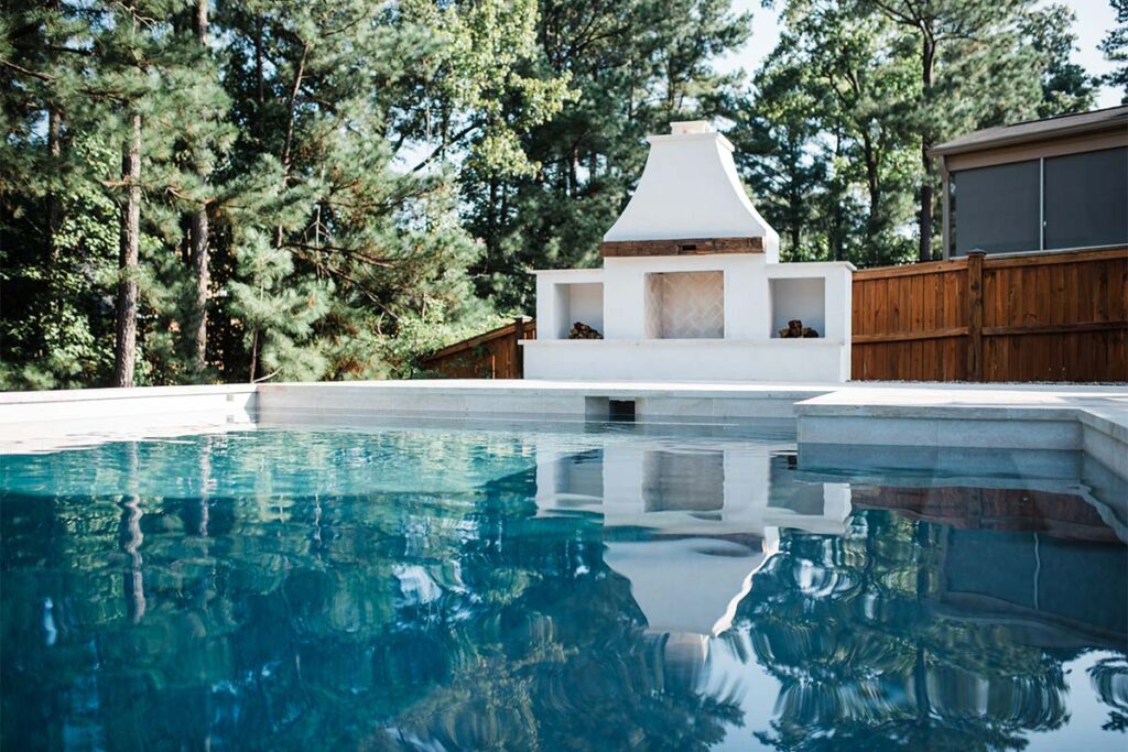 Contemporary Durham Concrete pool with contemporary fire place