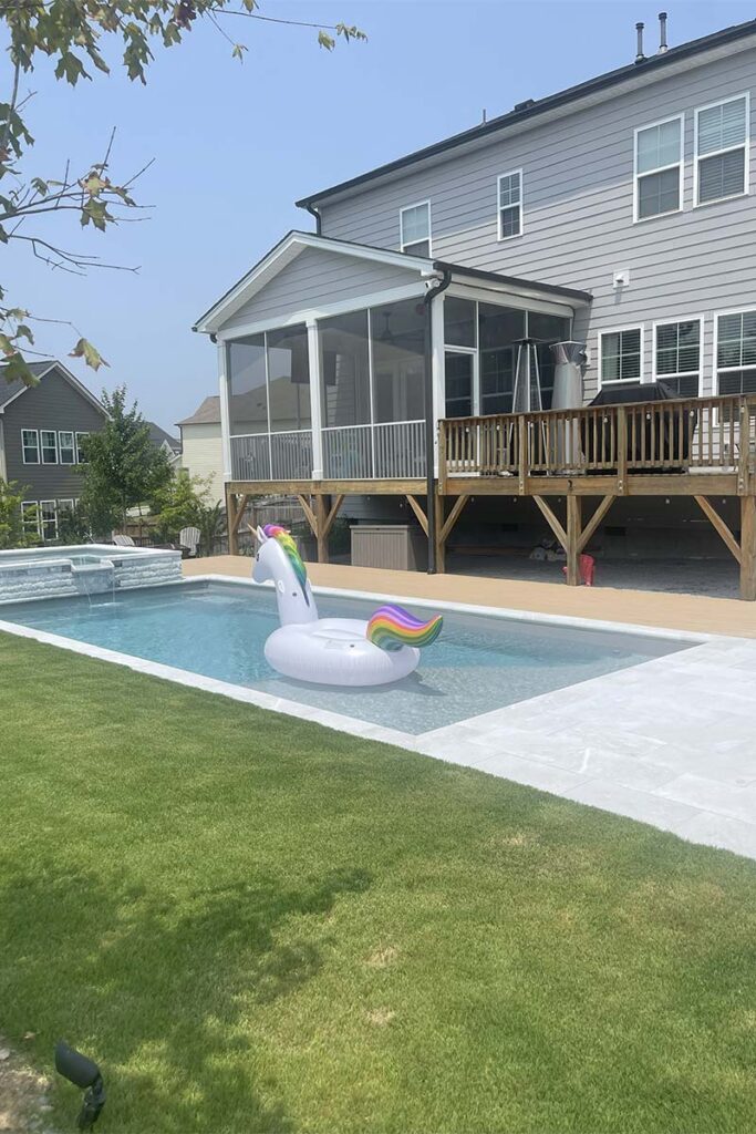 Fiberglass pool in Cary, with Afyon Cloud marble and TimberTec Composite wood decking