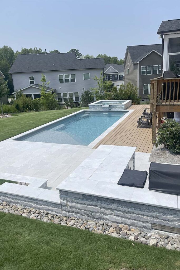 Zoomed out view of Fiberglass Cary with retaining wall and fiberglass pool