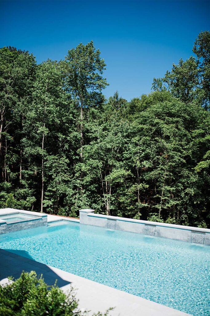 Zoomed out view of Formal Cary pool, showcasing White Diamond PebbleTec Plaster