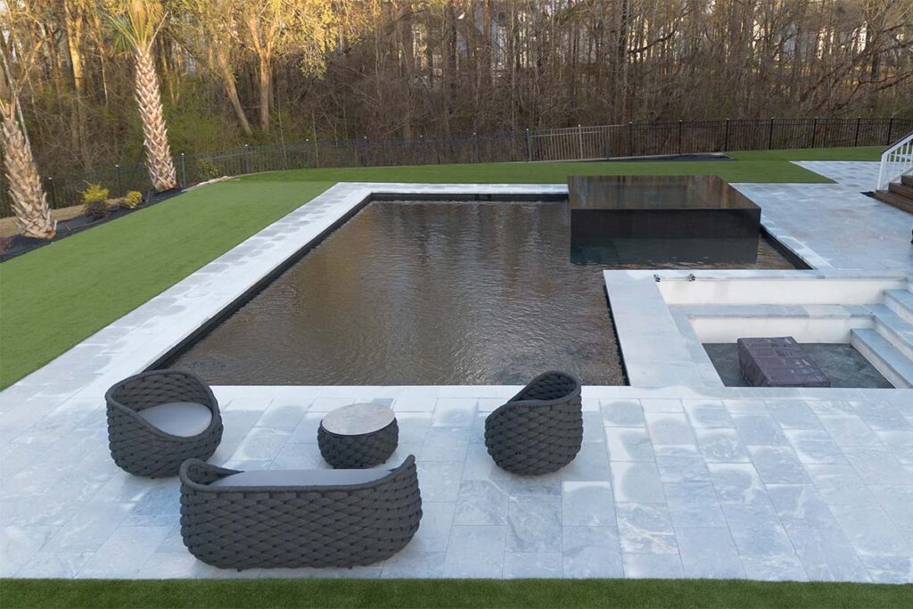 Sideview of Modern Apex during the day showcasing dark pool, monolithic spa inset, sunken lounge and outdoor furniture