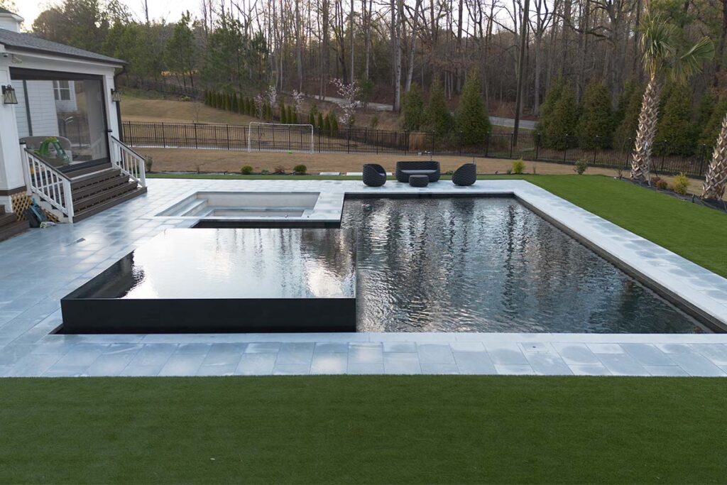 Side view of Modern Apex during the day showcasing dark pool and monolithic spa inset