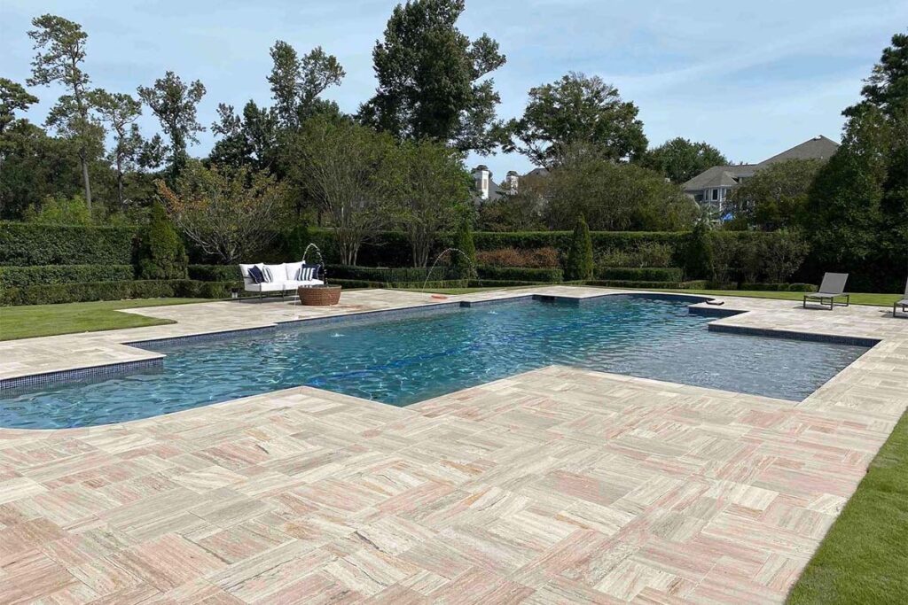 Corner view of Classic Costal pool with ledge allowing for pool loungers