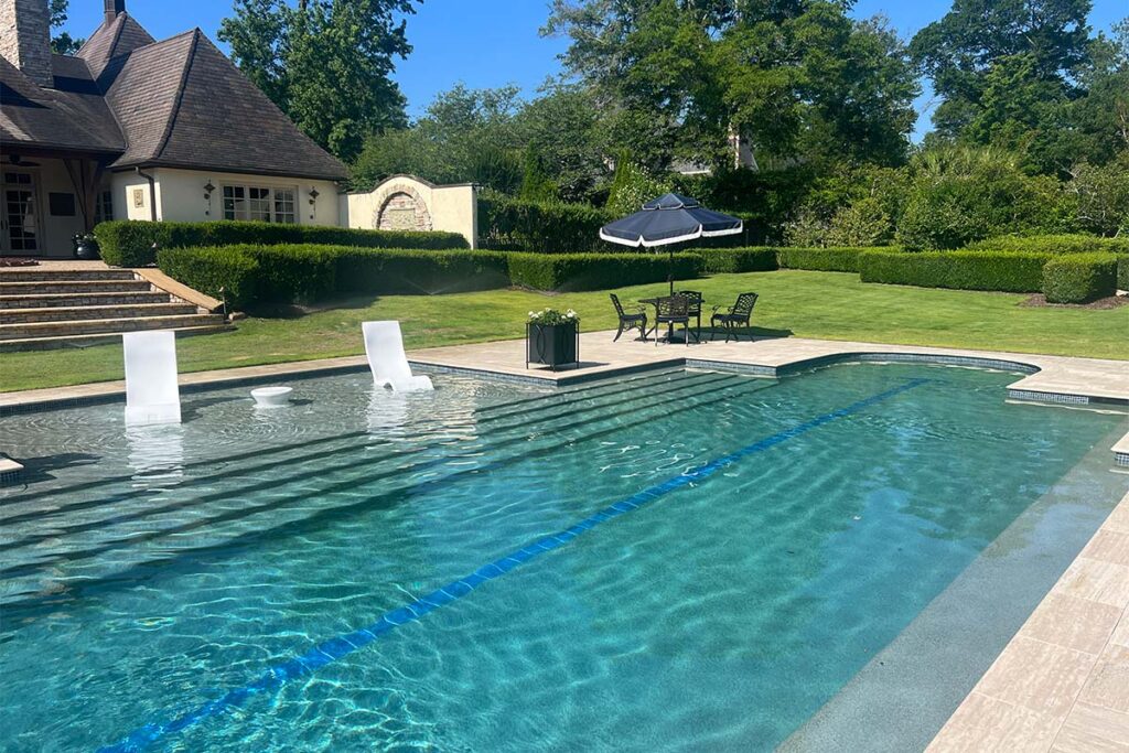 Custom shaped concrete pool with Greco/roman style