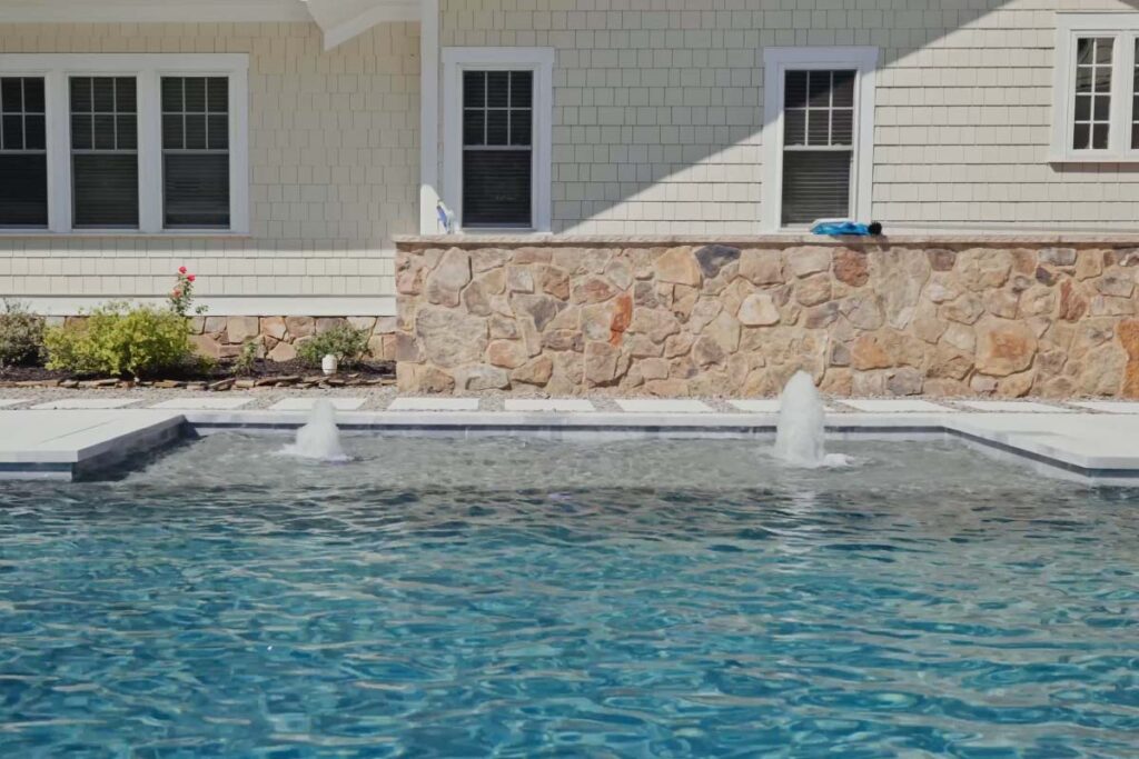 Front view of custom Concrete pool in Pinehurst NC. Pinehurst Contemporary features concrete pool with water jets